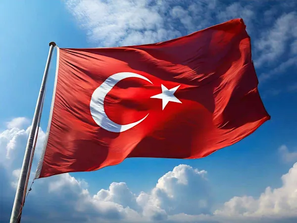 Turkey flag flying against a blue sky