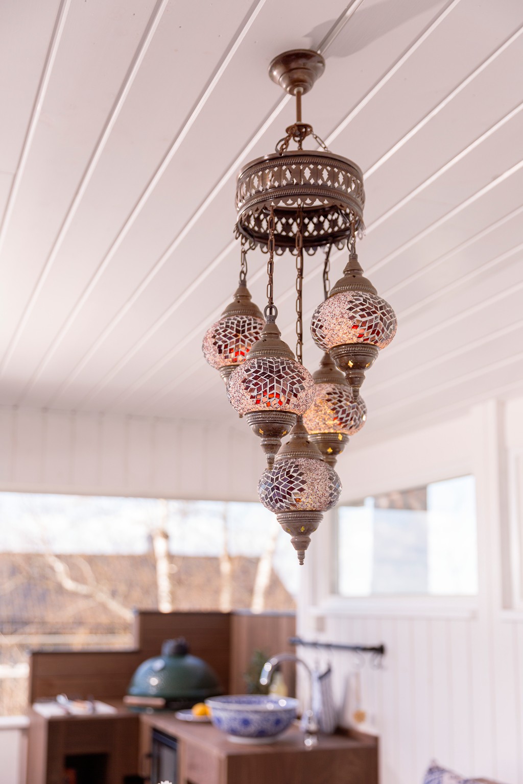 Dekorativ metalltaklampe med seks røde/lilla/gull mosaikkglass i lyst rom.