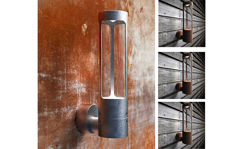 Sylinderformet utelampe i grått og rustent metall med vertikale åpninger.