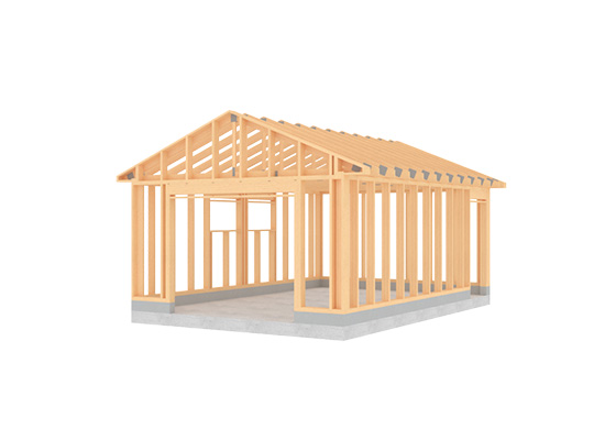 Lys trestomme av en enetasjes bygning med saltak på grå betongsåle.