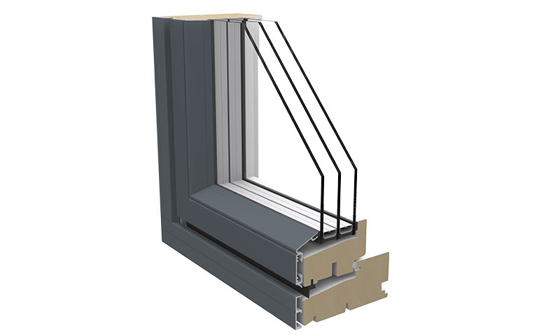 Tverrsnitt av mørk grå vinduskarm med trelags glass og lys tredetalj