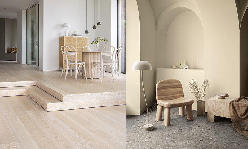 Lyst interiør med lys eikeparkett, rund spisegruppe på plattform og beige lesekrok med trestol.