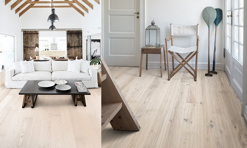 Skandinavisk stue og gang med hvit sofa, lerretsstol, sort bord, lyst tregulv og dekorative årer.