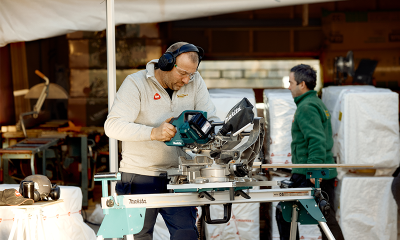 mann på byggeplass som bruker en kapp-og gjærsag