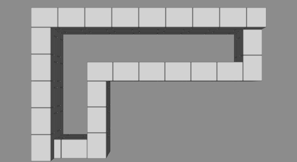 Oversikt av lysegrå rektangulære blokker i vinkeloppsett på grå bakgrunn.