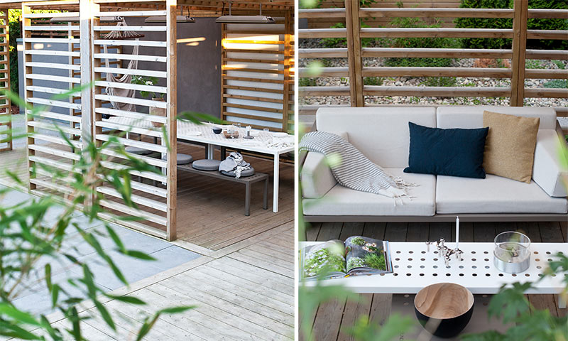 Moderne uterom med slankt tregitter, hvit spisegruppe og sofa med blå og beige puter