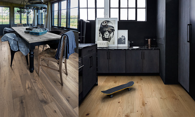 Lys eikeparkett med svart kjøkken, trebord med svarte stoler og skateboard på gulvet.