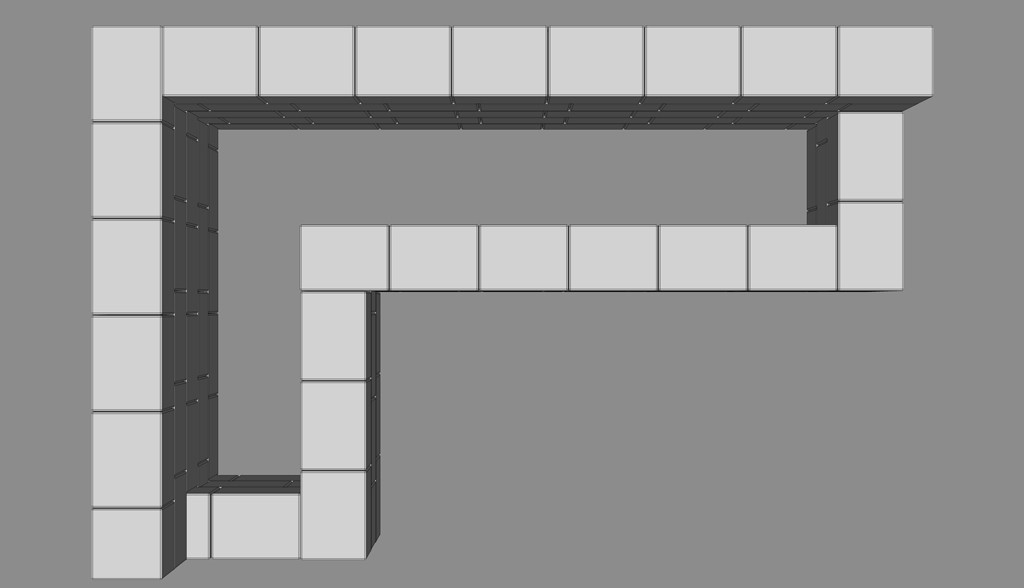 Oversiktsbilde i 3D av lyse og mørkegrå blokker som danner en L-formet korridor.