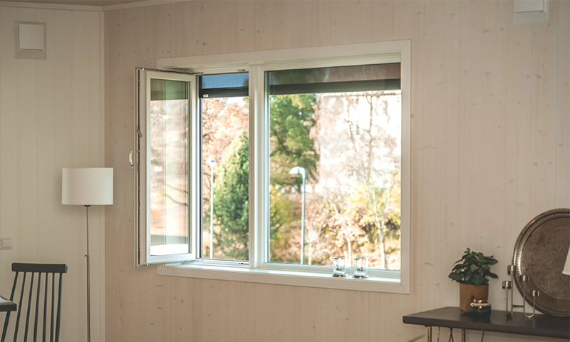 innadslående vindu på lys trevegg innendørs