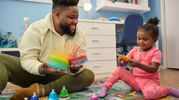 A father and daughter playing together.