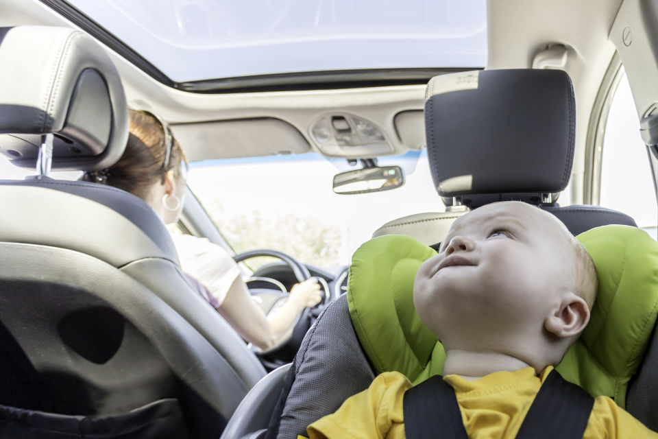 Baby boy in carseat riding in backseat of car