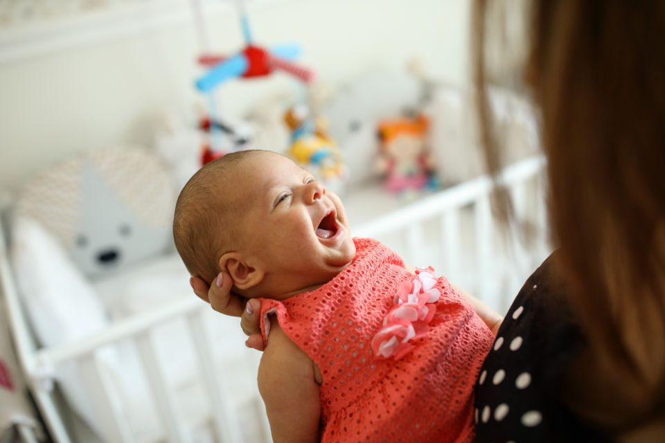 Newborn girl being held by mother