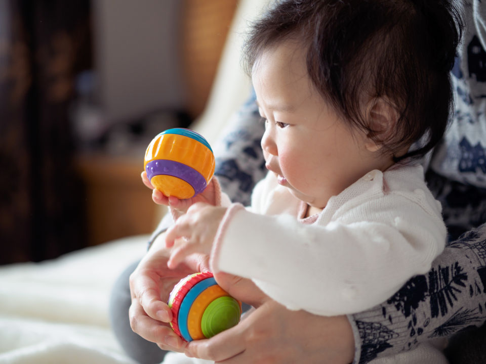 Baby with toy ball