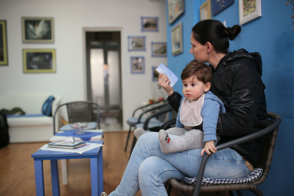 Mother waiting with baby in waiting room