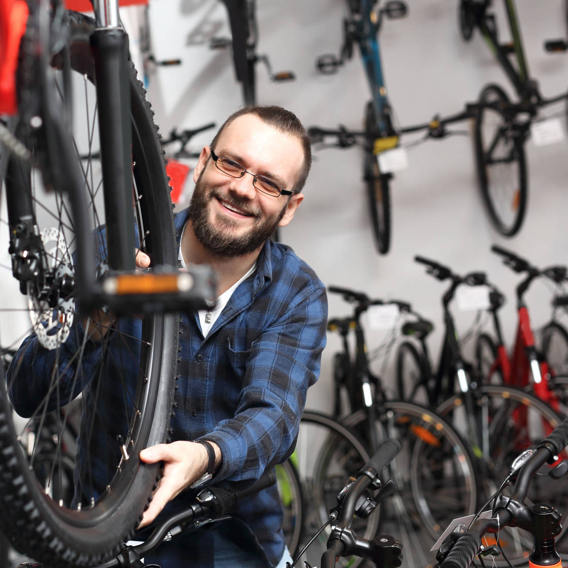 Bloke in a bike shop, surrounded by bikes