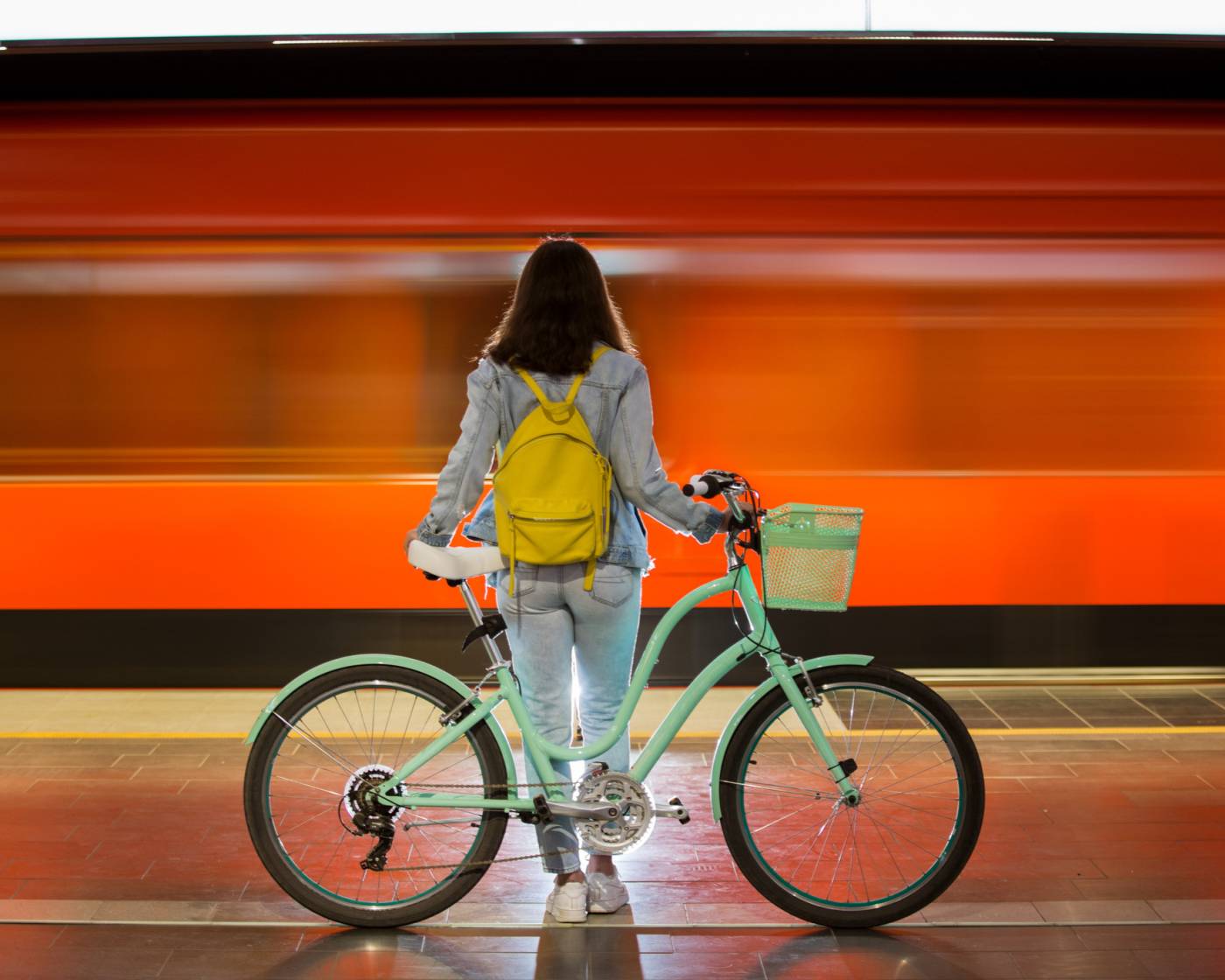 Woman with a bike standing on the train platform