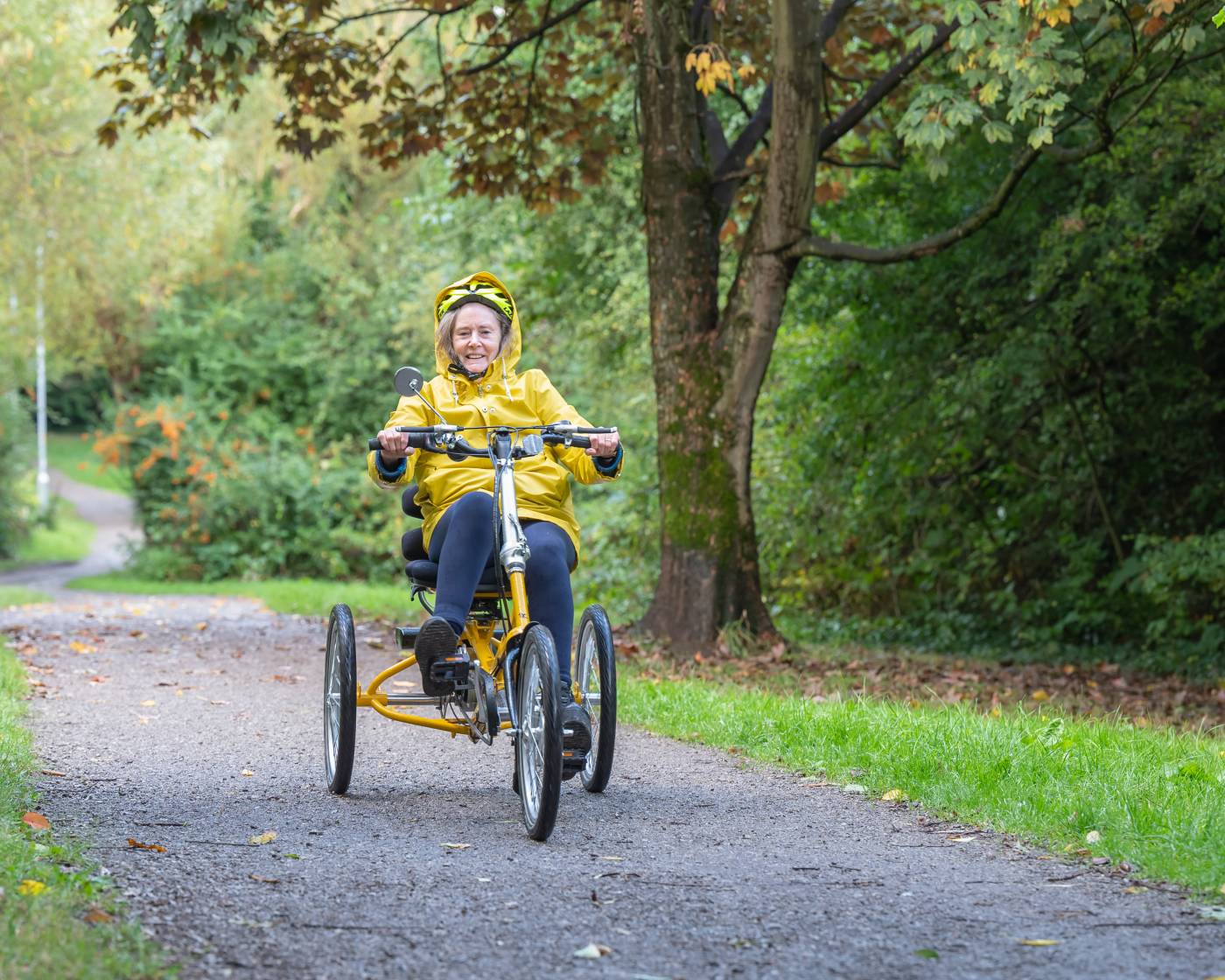 Woman riding trike in a park