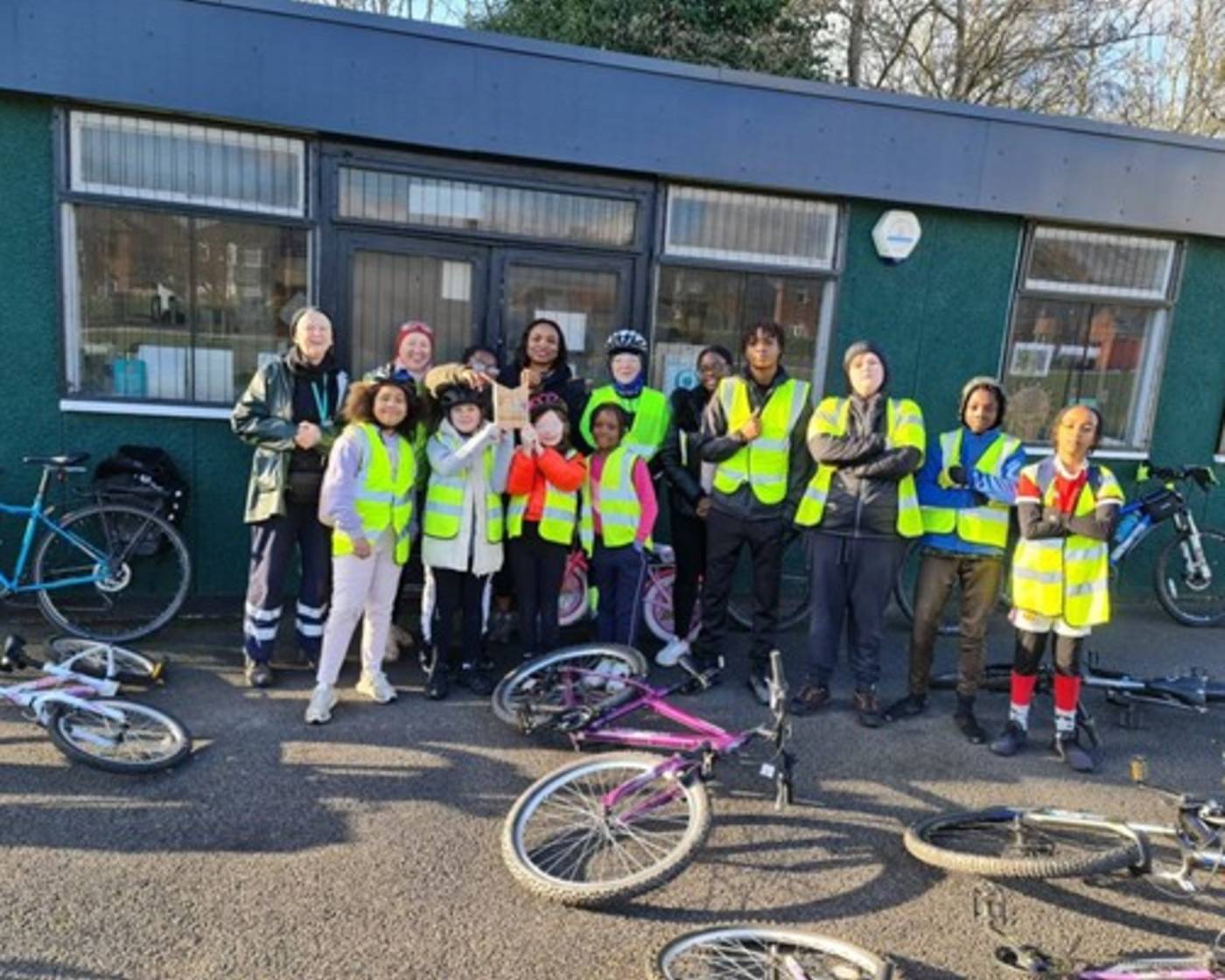 Pupils and teachers stood with their bicycles after a training session