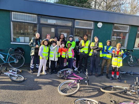 Pupils and teachers stood with their bicycles after a training session