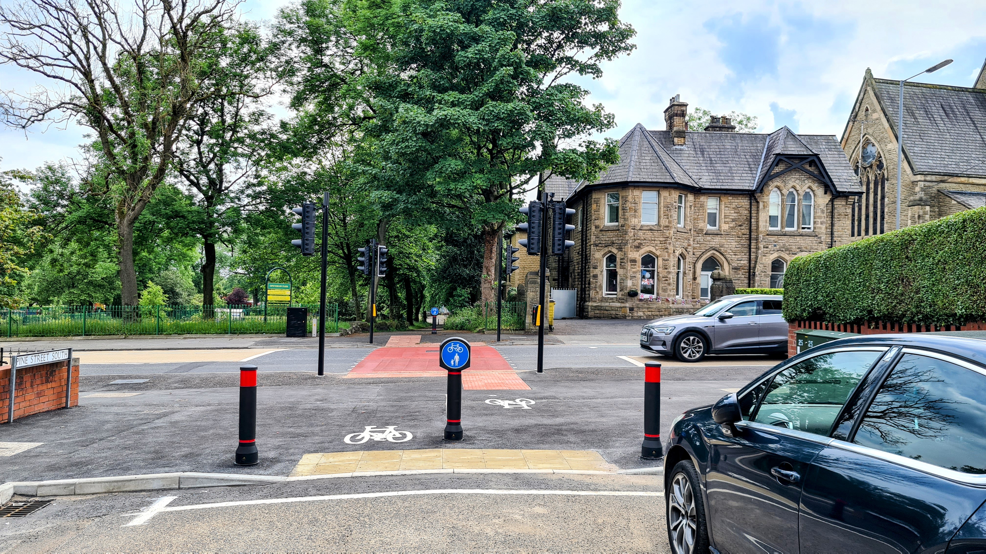A new signalised pedestrian and cycle crossing across Rochdale Road