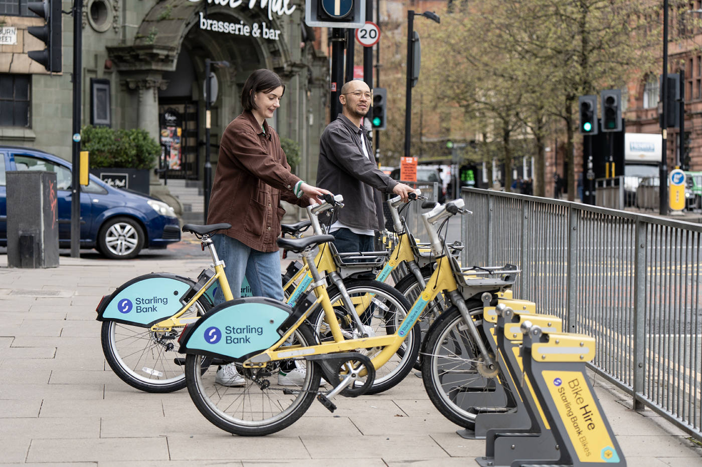 Two people using starling bank bikes