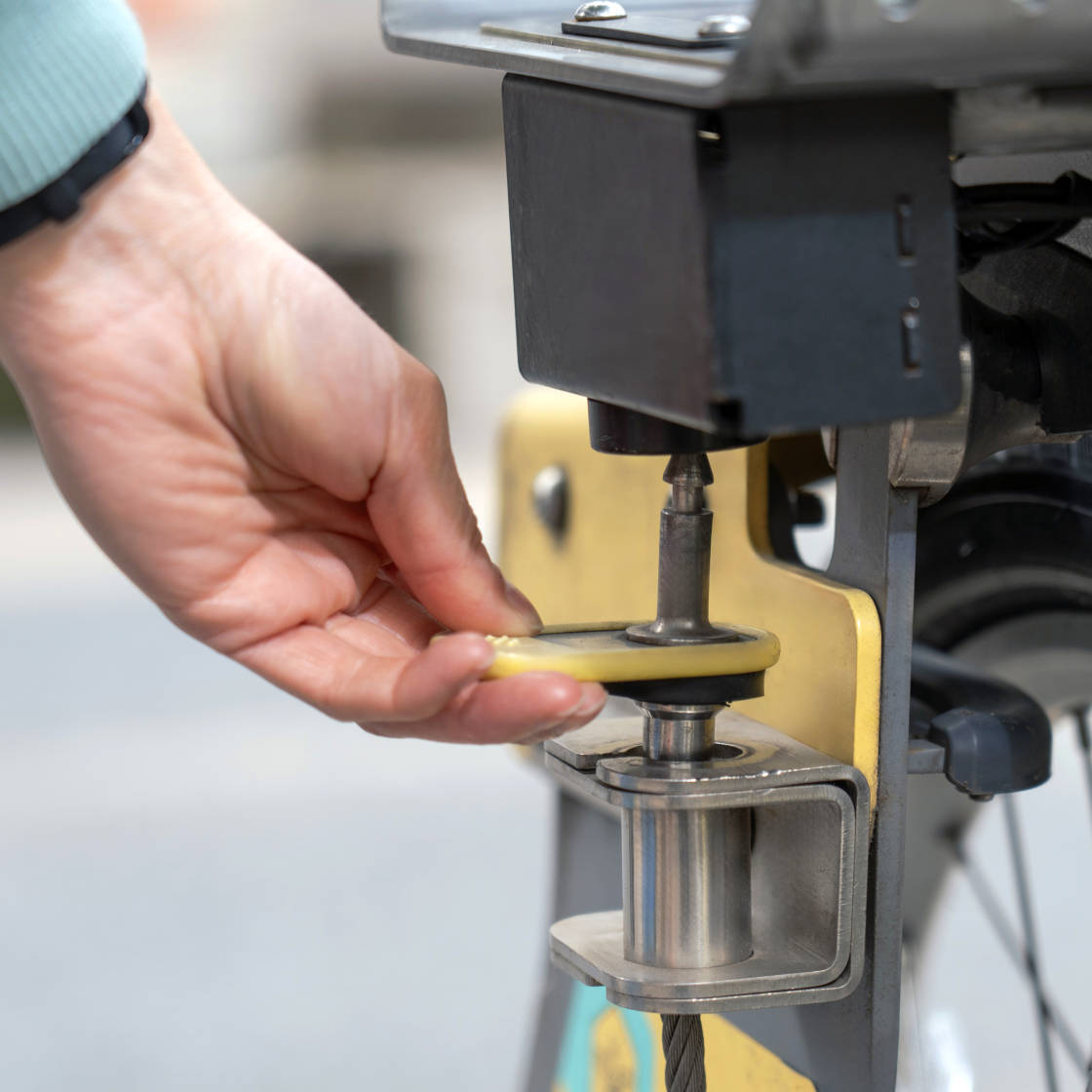 Person pushing up front lock on starling bank bike