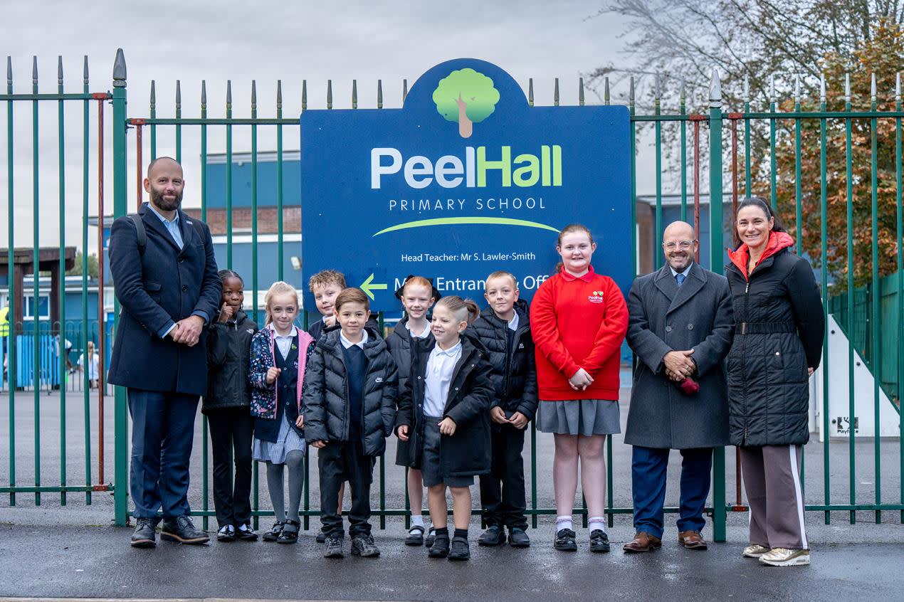 Group of people in front of school gates