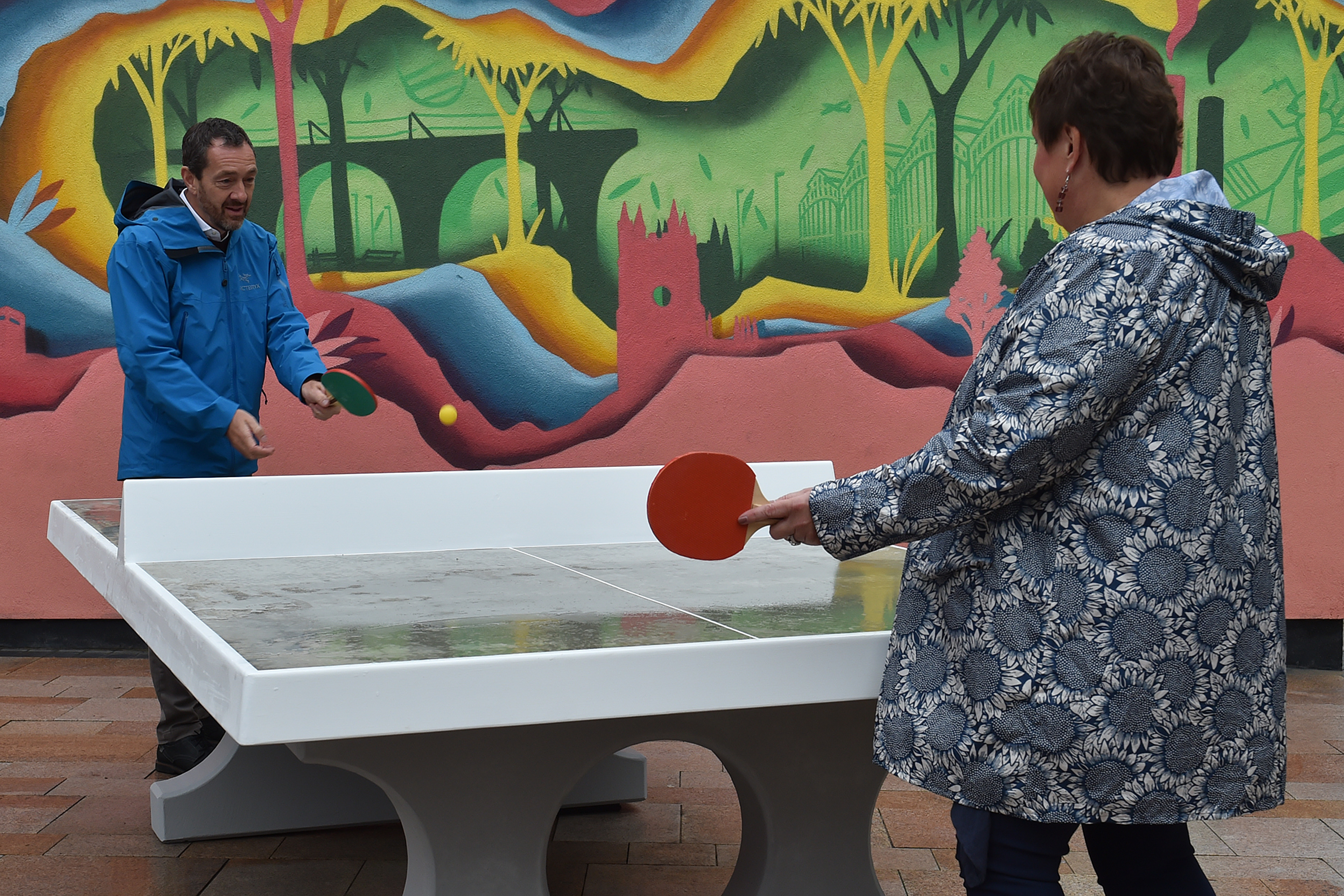 Chris Boardman and Councillor Jude Wells playing table tennis at Stockport parklet