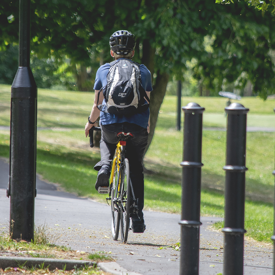 Person on a bike cycling through the park after using improved connections