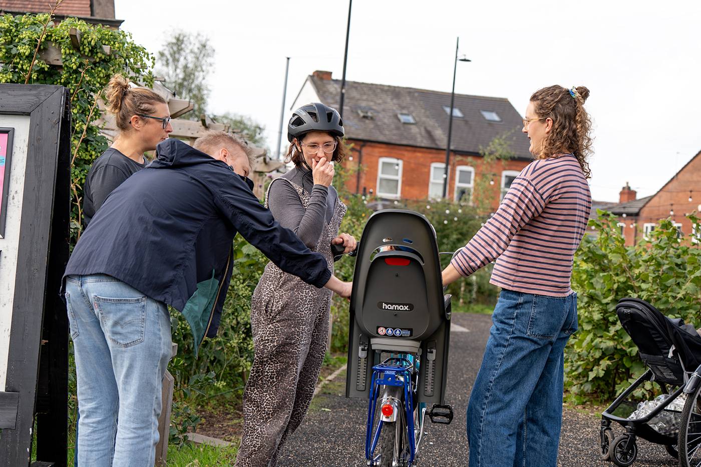 Parents stood with bike with toddler seat