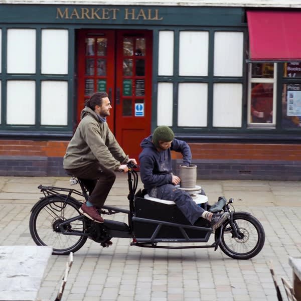 Two people riding a cargo bike