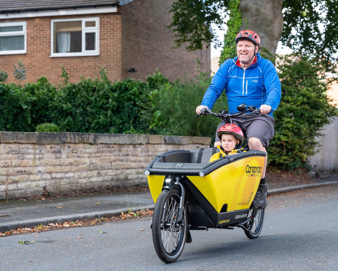 Man riding ecargo bike with child