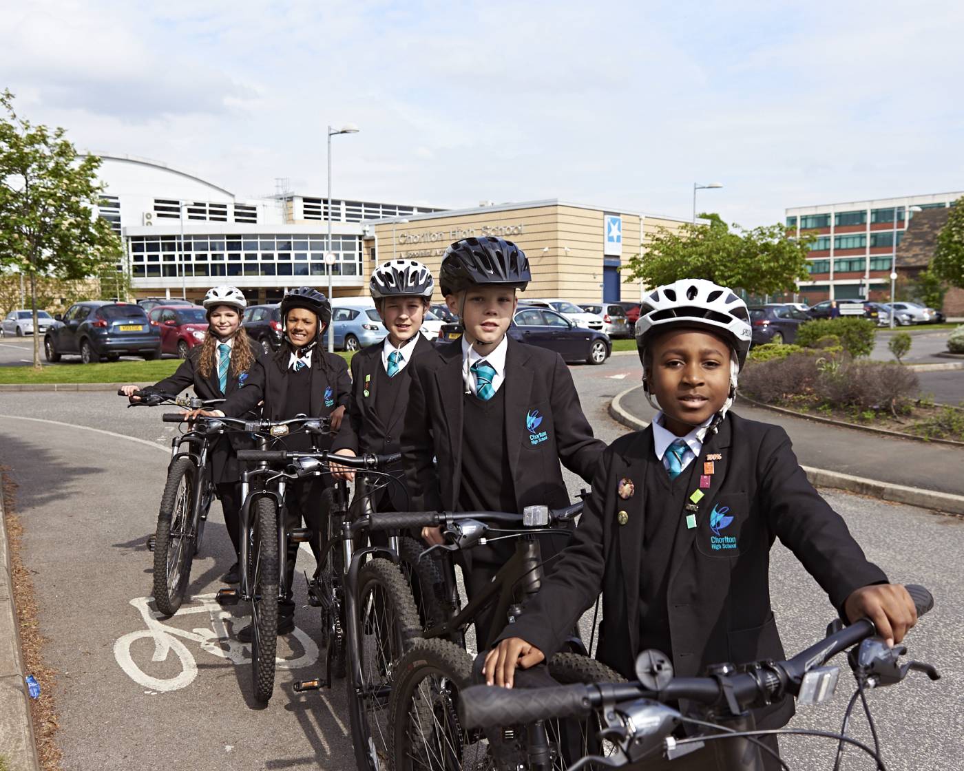 High school students stood next to their bikes on a cycle lane