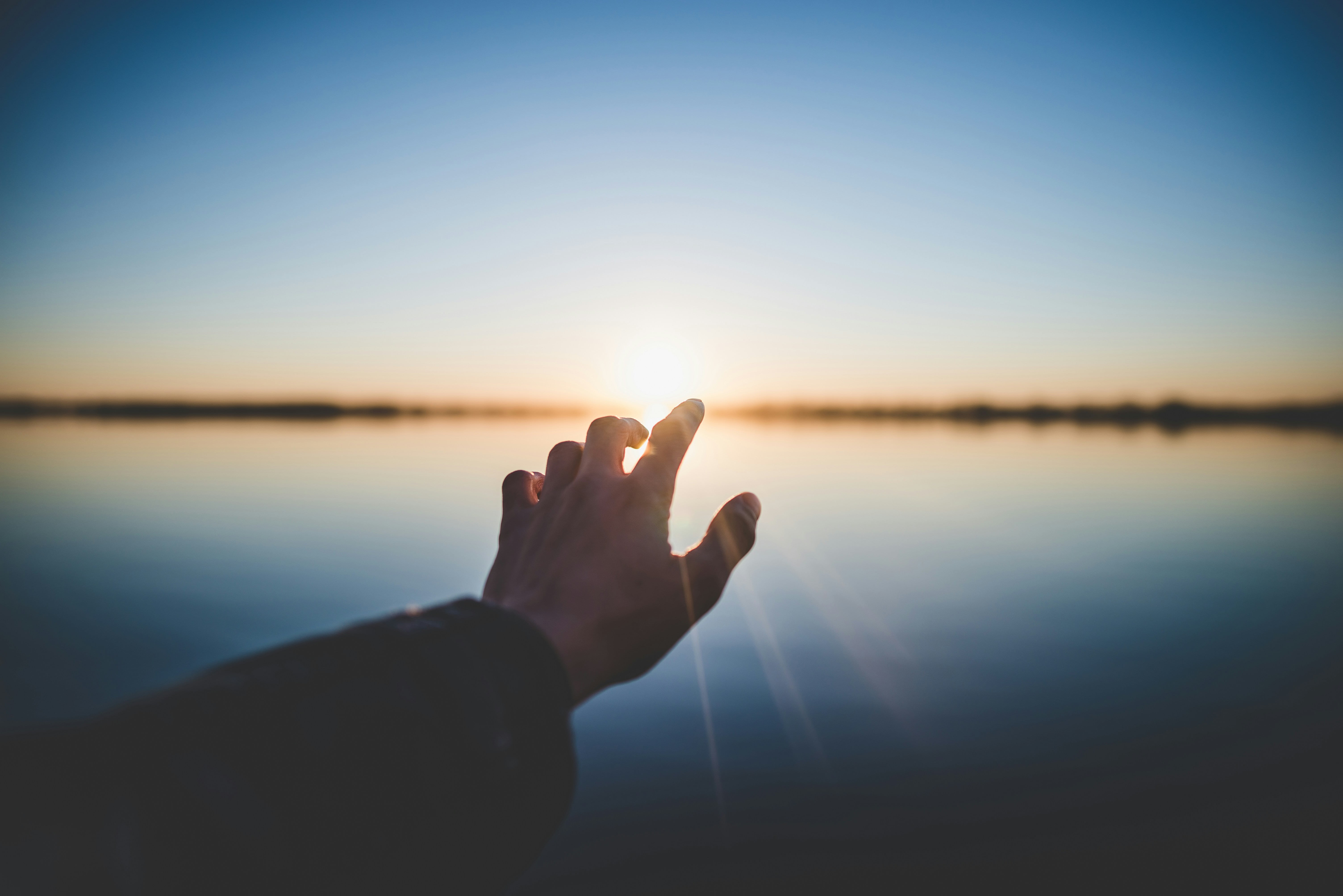 Hand in front of the ocean