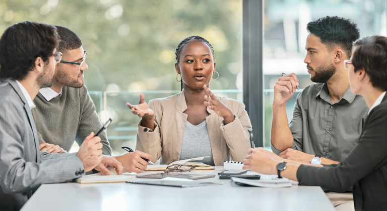 Workers talking in a meeting.