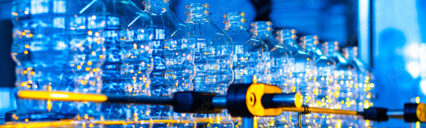 Plastic bottles on conveyor belt.