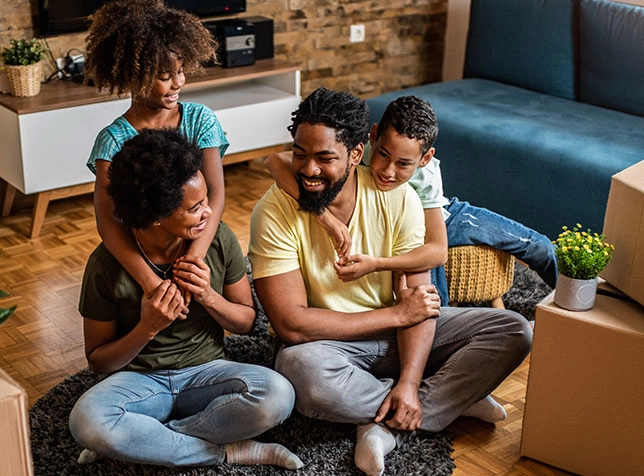 a family sitting happily together on the floor