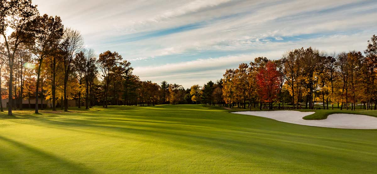 Sand traps and colored fall trees on hole 15 at the golf course