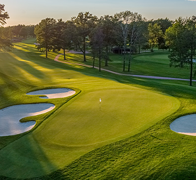 Aerial view of sand traps next to a putting green at the SentryWorld golf course