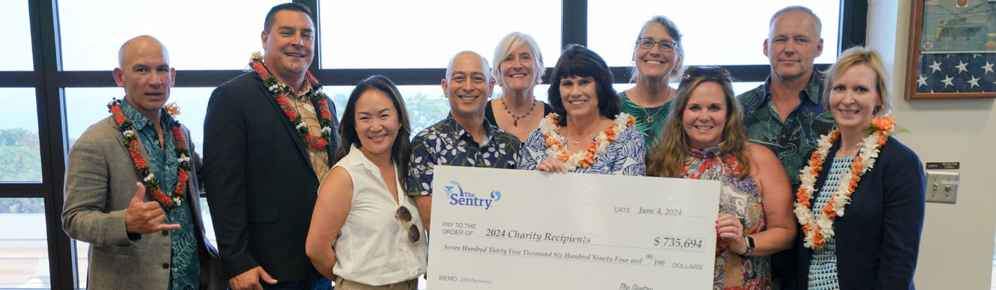 Sentry and PGA representatives with the donation check to Maui