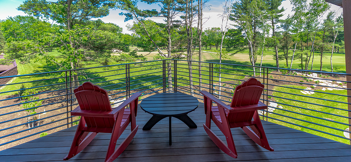 carousel-executive-king-suite-1br-7-1200x556 Executive level suite terrace with two chair overlooking the golf course.