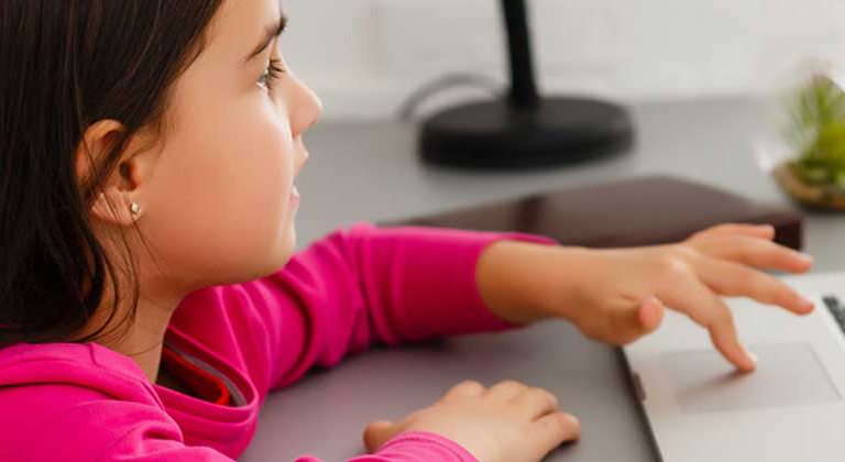 Child operating a laptop