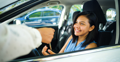 Young driver receiving keys