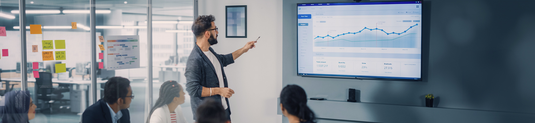 Man reviewing a chart with co-workers