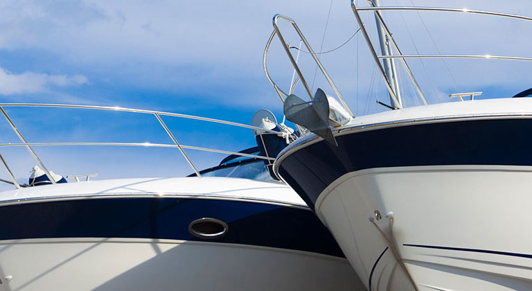 Two boats with a blue sky in background.