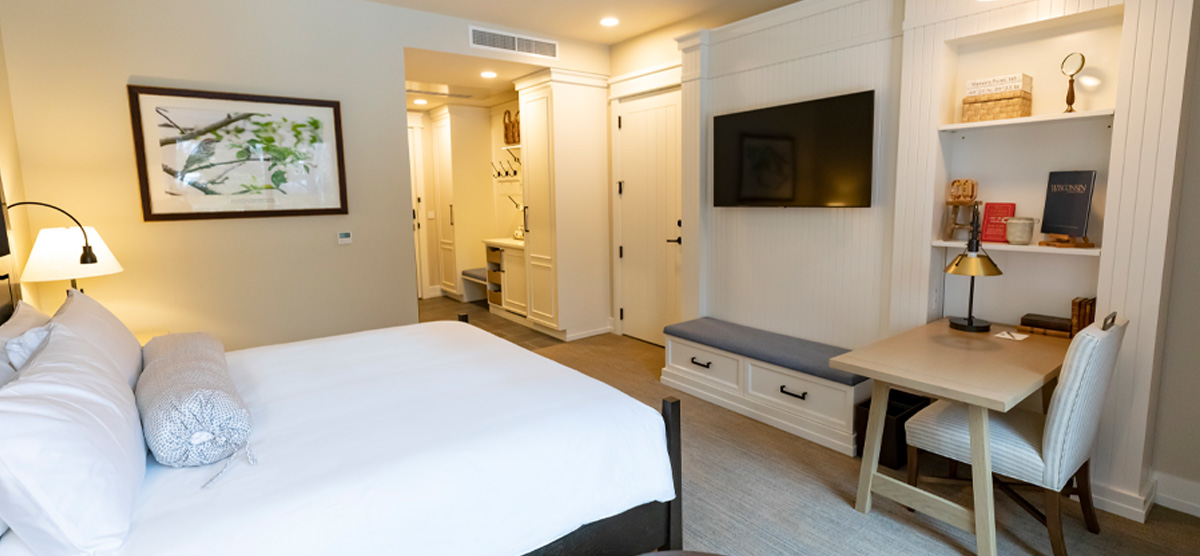 Bed, desk, and TV area in the King Suite in The Inn at SentryWorld