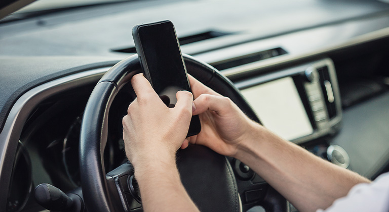 Person texting and driving distracted