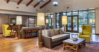 info-card-executive-level-345x182 Executive level lounge with couches, chairs, and terrace.