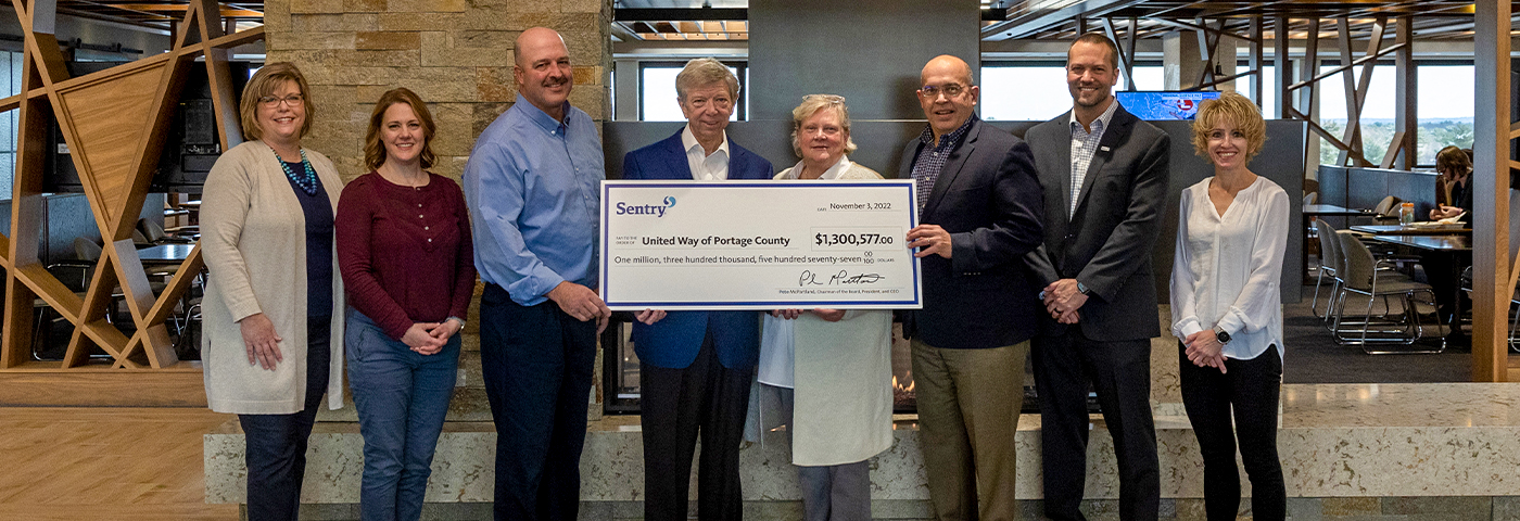 Sentry Insurance leaders with United Way donation check