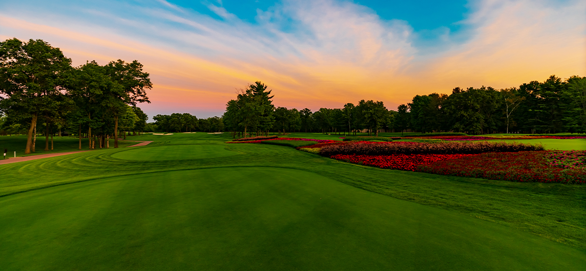 Sunset over a tee box next to the flower hole at SentryWorld